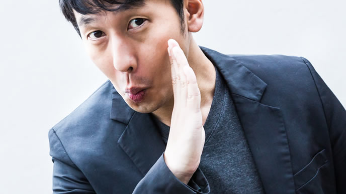 ひそひそ話しをする男性