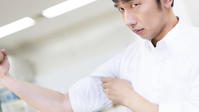 力コブを見せ付けて仕事を探す男性