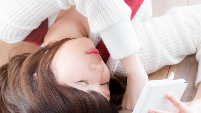 気が済むまで寝る読書中の女性