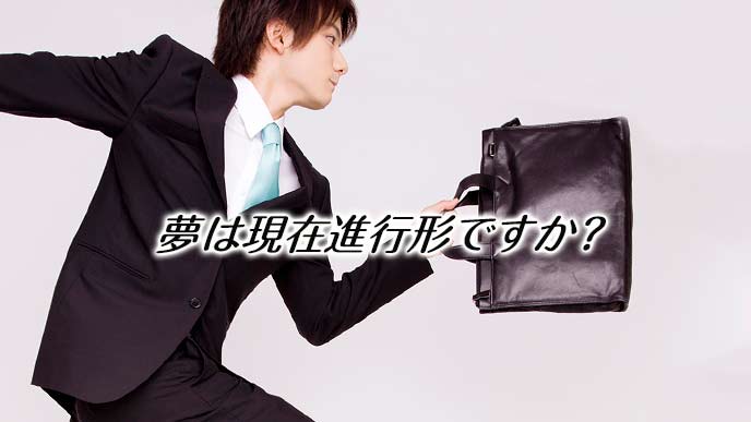 鞄を持って駆けるスーツ姿の男性