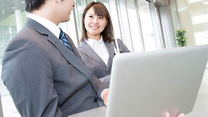 ラップトップで最新情報を見るビジネスマン