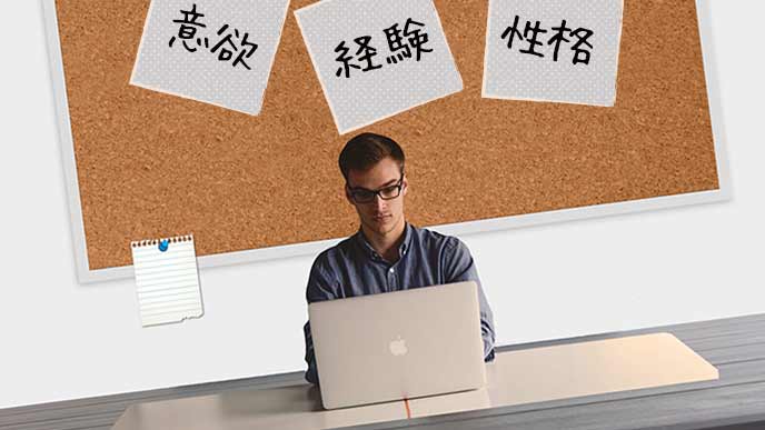 志望動機をパソコンで推敲する青年