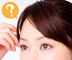 茶系の自分の髪を触る女性