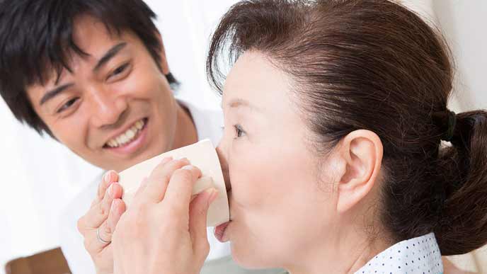 母親の介護をする男性