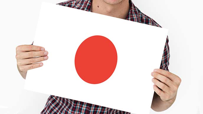 日本国旗を持つ男性
